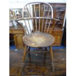 A 19TH CENTURY WINDSOR ARMCHAIR, with circular shaped seat and cross stretcher below (sd)