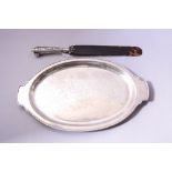 AN OVAL WHITE METAL TWIN HANDLED TRAY, with engraved tavern scene decoration to central panel and