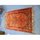 A HANDMADE TURKISH RED GROUND WOOL RUG, approximate size 168cm x 103cm, with certificate (sd)