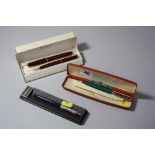 A BOXED PARKER SLIMFOLD PENSET, in maroon and gold, a Parker Jotter and a boxed Biro Deluxe in green