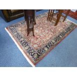 A PINK GROUND RUG, with dark blue outer border, G H Firth label attached, approximate size 198cm x