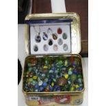 A TIN OF MARBLES, together with the twelve monthly healing stones set