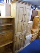 A SLIM PINE FOUR DOOR CUPBOARD, approximate size height 183cm x width 62cm x depth 31cm (key)