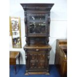 A VICTORIAN CARVED OAK GLAZED WALL CABINET, the solid base with geometric and lions mask detail,