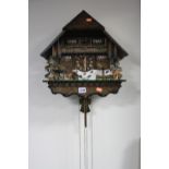 A CUCKOO CLOCK, in the form of a chalet, rack strike device, height approximately 41cm x width 39cm