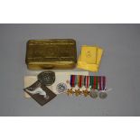 A CHRISTMAS 1914 TIN, including cigarettes paper and booklet and a miniature medal set