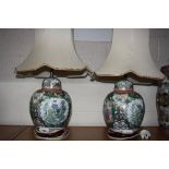 A PAIR OF CHINESE FAMILLE VERTE BULBOUS LAMP BASES AND SHADES, script, floral and insect details, on