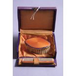 AN ENAMEL CHILD'S BRUSH AND COMB, in original box