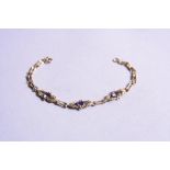 A 9CT THREE STONE AMETHYST BRACELET, approximate length 19cm, approximate weight 5.0 grams