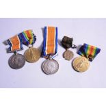 A SMALL BOX CONTAINING TWO GROUPS OF WWI MEDALS, British War and Victory medal correctly named to