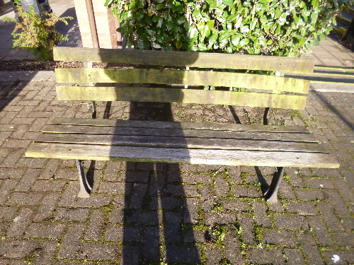 A CAST METAL PARK BENCH, with wooden slats, approximate size length 150cm x height 70cm x depth