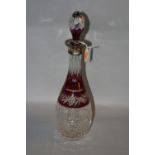 A RUBY FLASHED GLASS DECANTER, with silver collar, Birmingham mark, height approximately 38cm