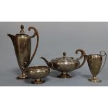 A SILVER FOUR PIECE ART DECO TEA SERVICE, comprising tapering hot water with ebonised high loop