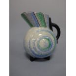 AN ART DECO STYLE LONGTON JUG, of bulbous form with green and blue stylised decoration to body