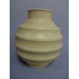 A KEITH MURRAY FOR WEDGWOOD CREAM COLOURED OVOID VASE, of ribbed form, approximately 25cm high