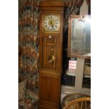 A GOLDEN OAK ARTS & CRAFTS STYLE LONGCASE CLOCK, the 10 inch square silvered dial having Arabic