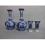 A PAIR OF DELFT BLUE AND WHITE VASES, with flared long neck over bulbous body with boats in full