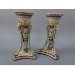 A PAIR OF CONTINENTAL MAJOLICA LONITZ VASES, of trumpet form having Rams head masks supported on