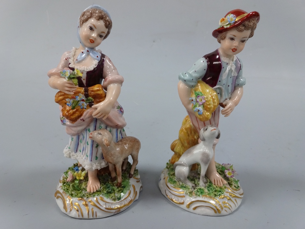 A PAIR OF NAPLES FIGURES, shepherd with dog at feet and shepherdess with lamb at feet, both carrying
