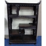 AN ORIENTAL HARDWOOD BOOKCASE, of open form having carved and moulded floral and leafage detail to
