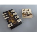 AN ORIENTAL GAMING COUNTER, the rectangular lacquered body with gilt floral decoration having