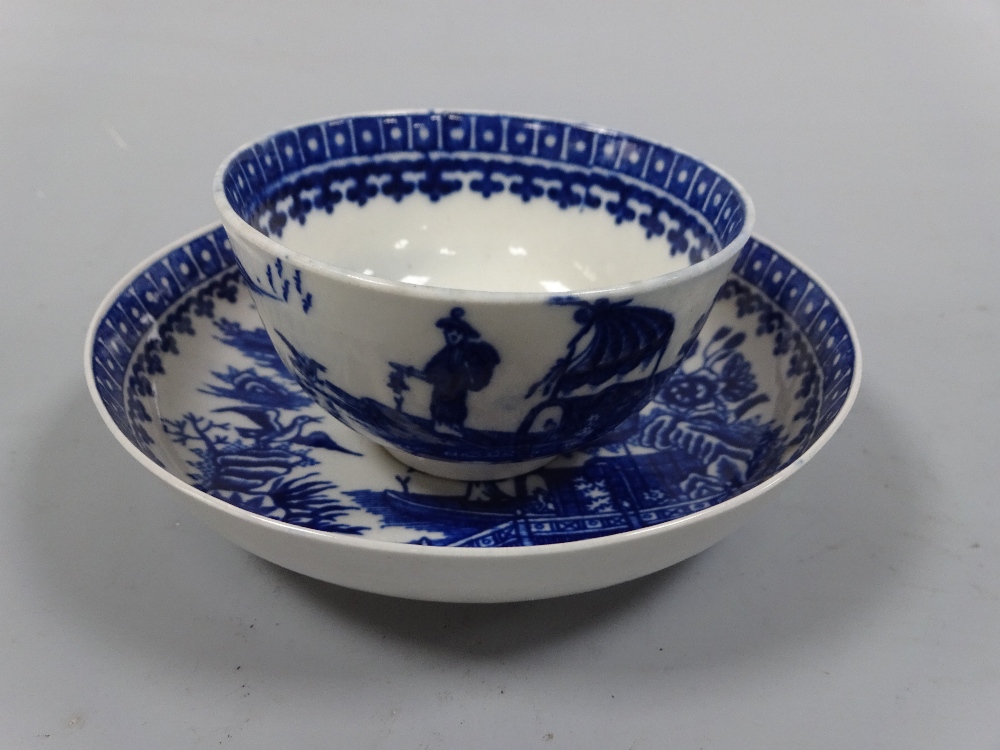 A WORCESTER BLUE AND WHITE TEA BOWL, decorated with figure fishing and landscapes, saucer