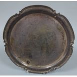 A SILVER PRESENTATION SALVER, having shaped and moulded circular rim, inscribed verso 'GW