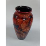 WILLIAM MOORCROFT FLAMBE LEAF AND BERRY PATTERN BALUSTER VASE, having signature and impressed