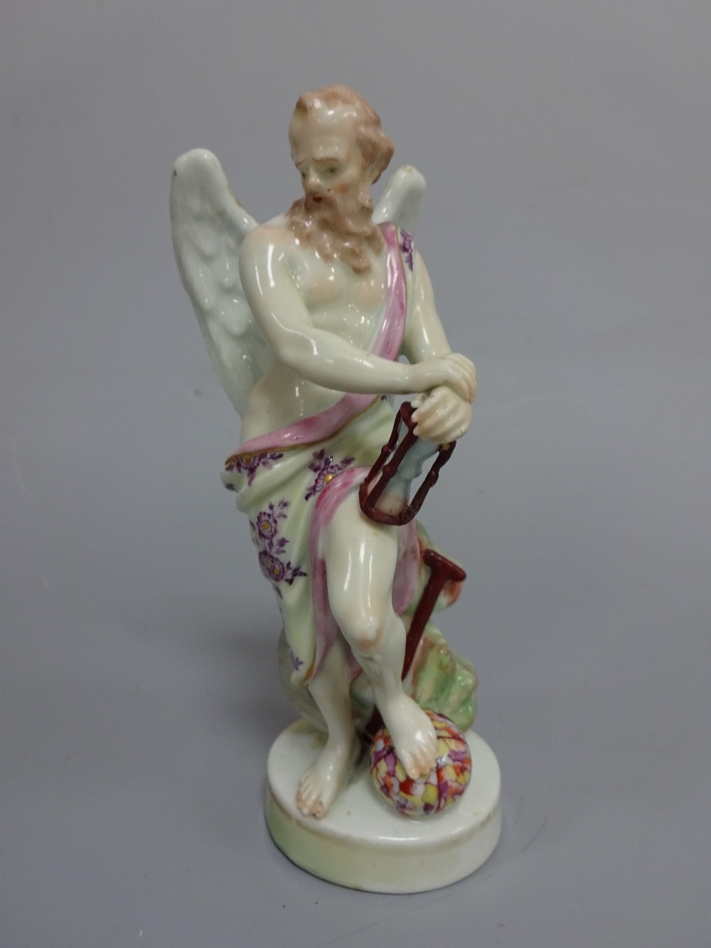 AN 18TH CENTURY DERBY FIGURE, modelled as Father Time, with Sands of Time resting on leg raised on