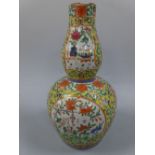 A CHINESE FAMILLE JAUNE PORCELAIN DOUBLE GOURD SHAPED VASE, decorated in polychrome enamels with