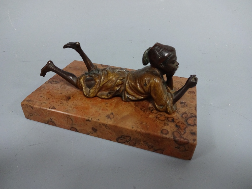 A COLD PAINTED BERGMANN FIGURE, modelled as young Arab boy lying on front smoking, impressed