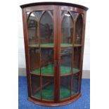 A 19TH CENTURY MAHOGANY INLAID BARREL FRONT GLAZED CORNER CABINET, with string inlaid doors to three