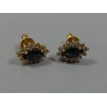 A PAIR OF SAPPHIRE AND DIAMOND EAR STUDS, with marquise shape sapphire within a surround of