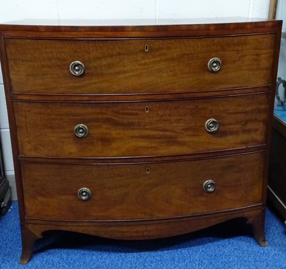 A 19TH CENTURY MAHOGANY BOW FRONT CHEST OF THREE GRADUATED LONG DRAWERS, on shaped splayed feet,