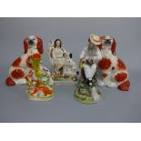 A PAIR OF STAFFORDSHIRE SPANIELS, approximately 20cm high, figure with dog at side, approximately