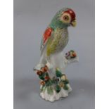 A DERBY PARAKEET FIGURE, c.1765, on floral encrusted branch, approximately 9.5cm high (a/f) (D.