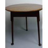 A CIRCULAR TOPPED OAK CRICKET TABLE, having turned legs and pad feet, approximately 64cm diameter