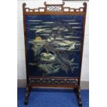 AN ORIENTAL ROSEWOOD FRAMED FIRE SCREEN, having pagoda top over cranes in trees before sunshine