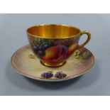 A ROYAL WORCESTER CABINET CUP AND SAUCER, hand painted with peaches, grapes and berries to mossy