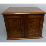 A BURR WALNUT PART CANTEEN OF PLATED CUTLERY, with double doors to five drawer interior, brass