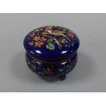 A CONTINENTAL HAND ENAMELLED HINGED LIDDED CIRCULAR SEWING BOX, having relief moulded bird of