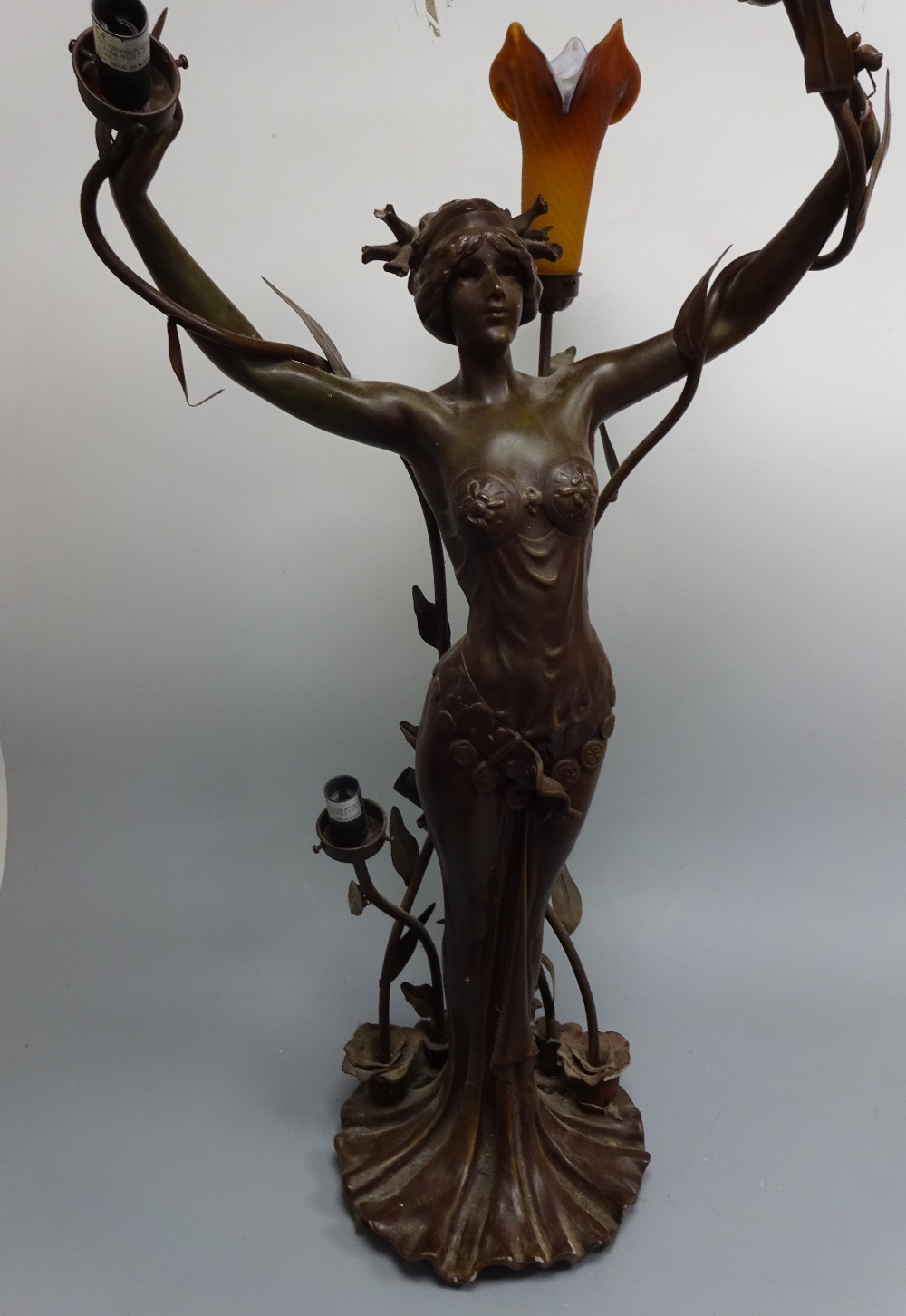 A THREE BRANCH FIGURAL LAMP, modelled as scantily clad Art Nouveau maiden with naturalistic