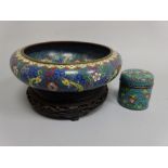 A CLOISONNE BOWL, decorated with dragons, flowers and scroll detail, set on pierced hardwood