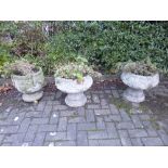 A PAIR OF COMPOSITE GARDEN URNS, and another composite garden urn (3)