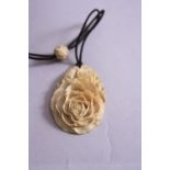 A LATE 19TH CENTURY IVORY PENDANT, carved as a Lotus Flower (signed to back)