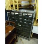 AN INDUSTRIAL STYLE BANK OF THIRTY TWO VARIOUS SIZED WORKSHOP DRAWERS, with an octer metal frame