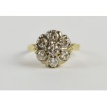 An 18ct yellow and white gold seven stone diamond cluster ring, approx size M, approx 12mm diameter,