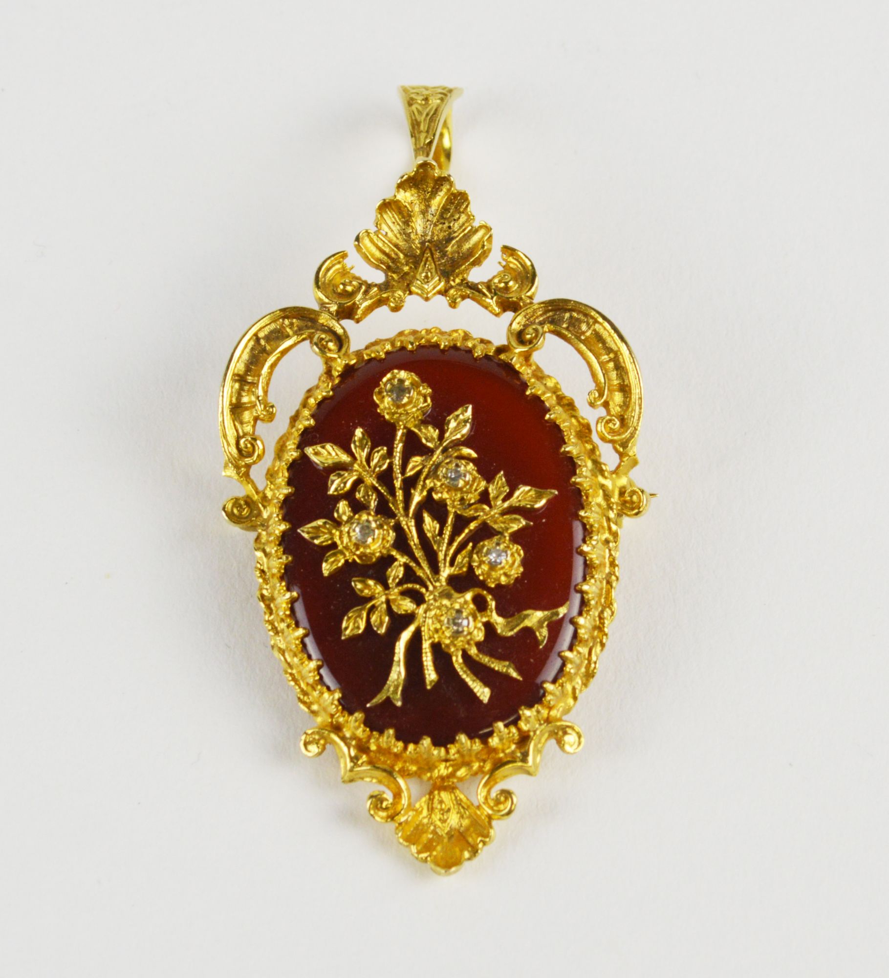 A 9ct gold, carnelian and diamond set brooch in the Rococo revival brooch / pendant,