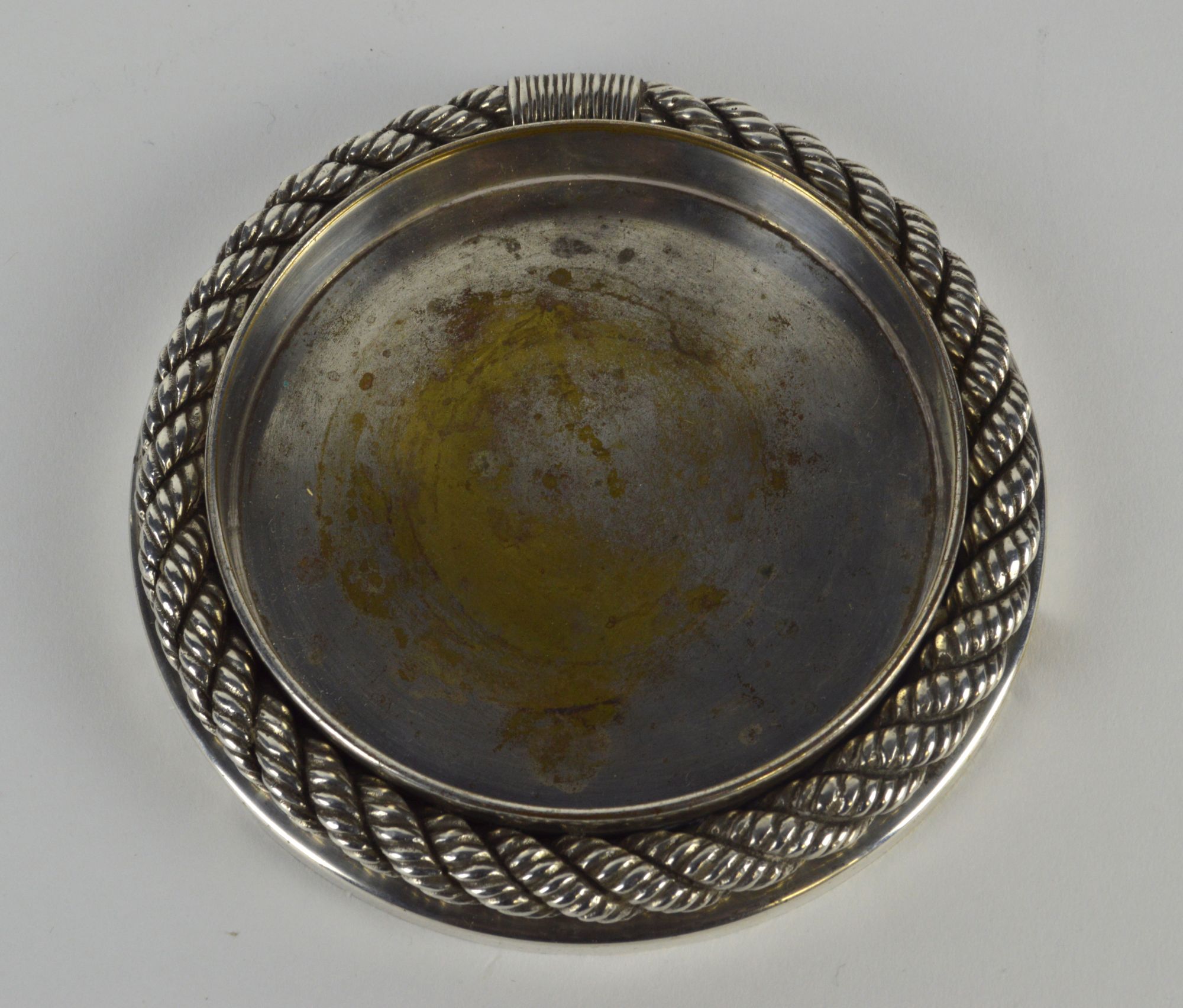 An Hermes silver plated bottle coater, of circular form, with bold rope border,