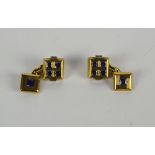 A pair unmarked yellow metal (tests as 18ct gold) and sapphire set cufflinks,